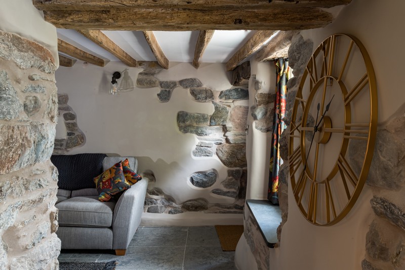Tongue_Cottage-30 Living area with exposed beams and stonework